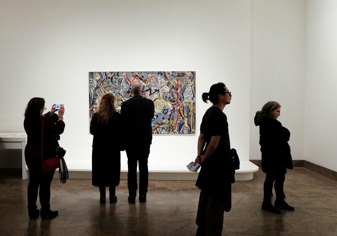 Visitors viewing a painting – Egypt International Art Fair